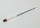 Das Bild zeigt ein Glasgerät, wahrscheinlich ein Thermometer oder einen Hydrometer, mit einer skalierten Messröhre und einer gefärbten Flüssigkeit am unteren Ende. Es dient zur Durchführung von Experimenten im Bildungswesen, insbesondere in den Naturwissenschaften.