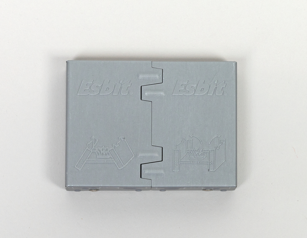 Das Bild zeigt eine graue Box mit dem Logo „Esbit“. Sie ist für Experimentierzwecke konzipiert und trägt Zeichnungen, die wahrscheinlich die Nutzung oder Funktionen des Inhalts darstellen.