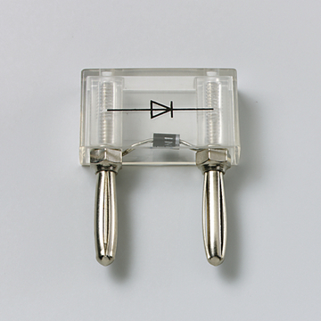 Das Bild zeigt ein transparentes elektrisches Experimentiergerät, das eine Diode darstellt. Es verfügt über zwei Metallkontakte und sind für den Einsatz im Bildungsbereich bestimmt, um die Funktionsweise von Dioden zu demonstrieren.