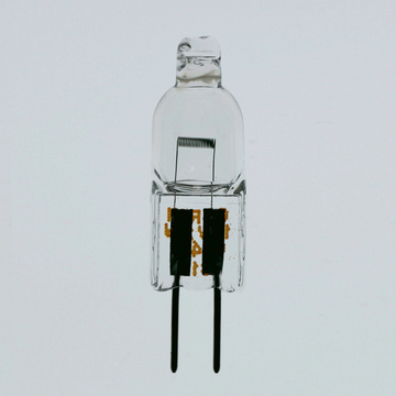 Das Bild zeigt eine transparente Halogenlampe, die für experimentelle Zwecke genutzt werden kann. Die Lampe hat zwei stromleitende Kontakte und einen transparenten Glaskörper, der das Leuchtmittel enthält.