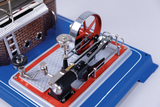 Das Bild zeigt ein detailliertes Modell einer Dampfmaschine, das auf einer farbigen Plattenbasis montiert ist. Es sind verschiedene mechanische Teile wie das Schwungrad und die Verbindungsstange sichtbar, die zur Demonstration der Funktionsweise eingesetzt werden können.