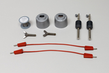 Ein Set für physikalische Experimente zeigt zwei silberne Halterungen, passende Schrauben und zwei rote Verbindungskabel. Zusätzlich sind eine Spule mit Konstantandraht sowie zwei Metallstifte mit grauen Griffen abgebildet.